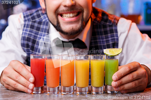 Image of Barman at work, preparing cocktails.