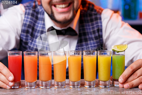 Image of Barman at work, preparing cocktails.