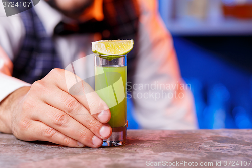 Image of Barman at work, preparing cocktails.