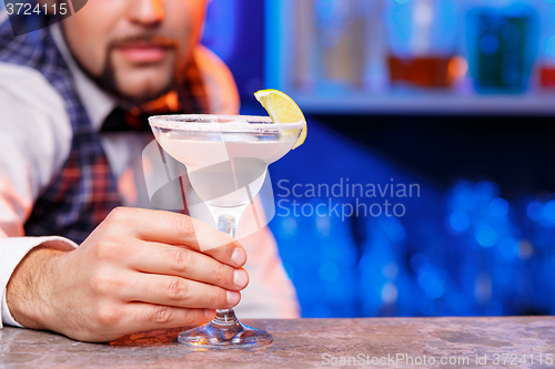 Image of Barman at work, preparing cocktails.