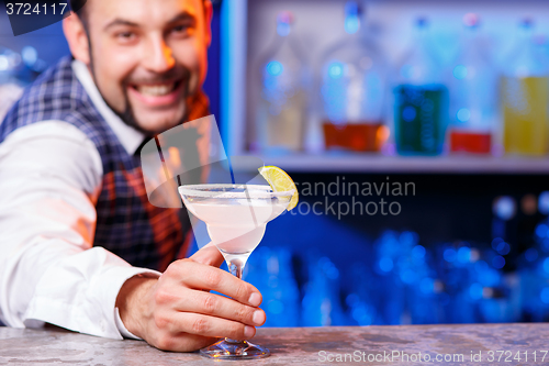 Image of Barman at work, preparing cocktails.