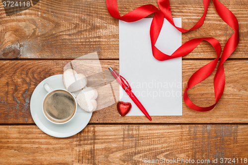 Image of The blank sheet of paper and pen with small hearts  