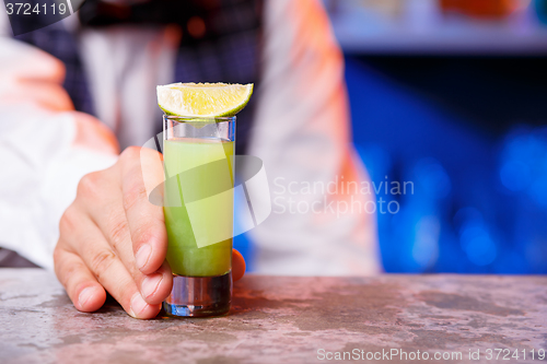 Image of Barman at work, preparing cocktails.