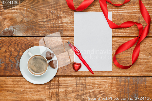 Image of The blank sheet of paper and pen with small hearts  