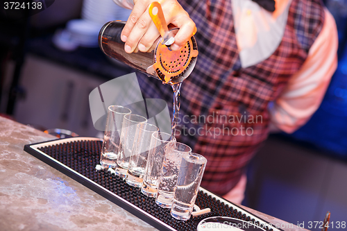 Image of Barman at work, preparing cocktails.