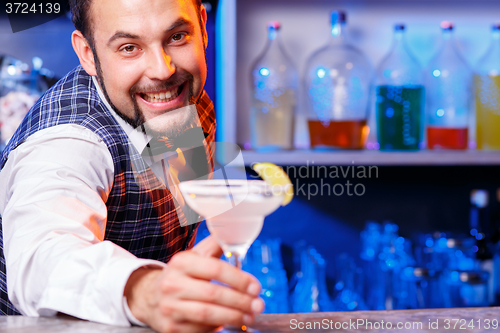 Image of Barman at work, preparing cocktails.