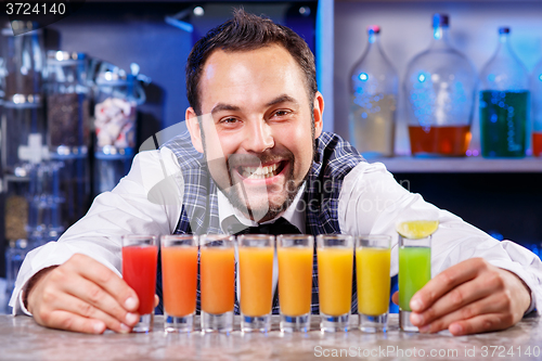 Image of Barman at work, preparing cocktails.