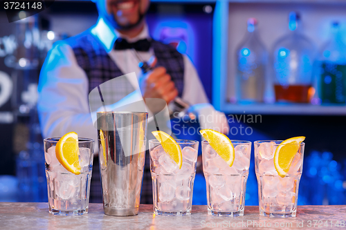 Image of Barman at work, preparing cocktails.