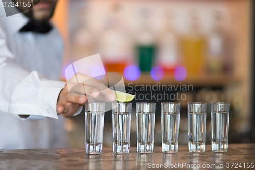 Image of Barman at work, preparing cocktails.