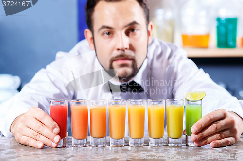 Image of Barman at work, preparing cocktails.