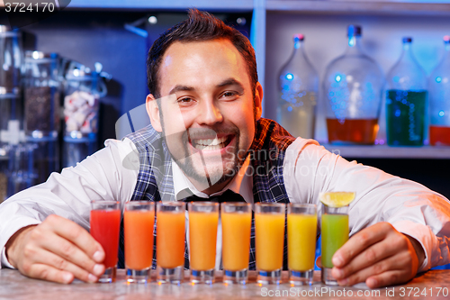 Image of Barman at work, preparing cocktails.