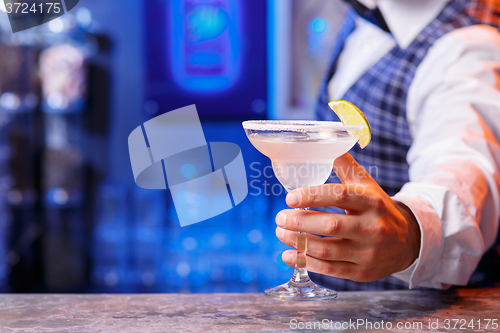 Image of Barman at work, preparing cocktails.