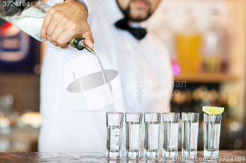 Image of Barman at work, preparing cocktails.