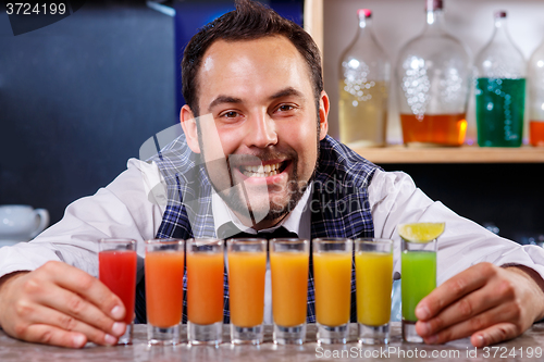 Image of Barman at work, preparing cocktails.