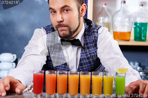 Image of Barman at work, preparing cocktails.