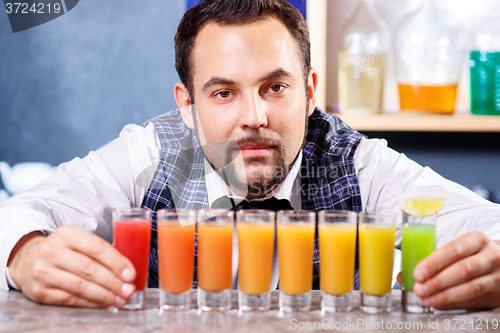 Image of Barman at work, preparing cocktails.