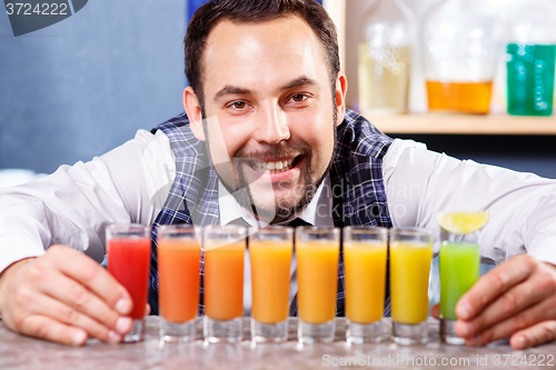 Image of Barman at work, preparing cocktails.