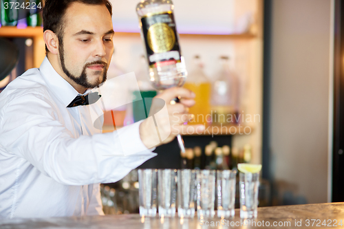 Image of Barman at work, preparing cocktails.