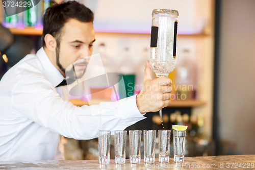 Image of Barman at work, preparing cocktails.