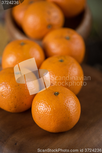 Image of tangerines on wooden background