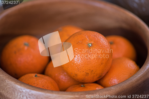 Image of tangerines on wooden background