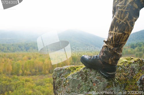 Image of Tourist at sunrise in mountain