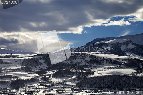 Image of Winter mountains and village at evening