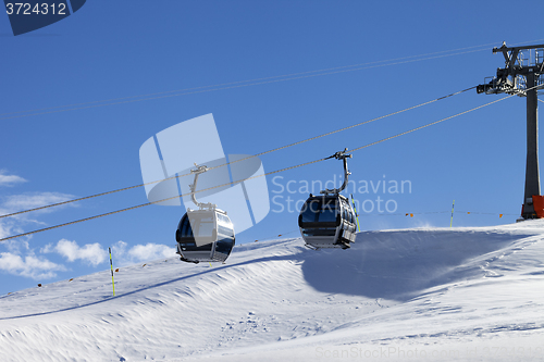 Image of Gondola lift on ski resort at windy sun day