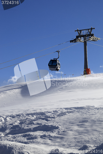 Image of Gondola lift on ski resort at windy sun day