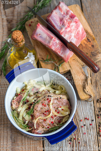 Image of Pork marinated in olive oil, a mixture of peppers and rosemary.