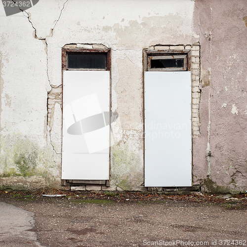 Image of abandoned wooden house with boarded up windows