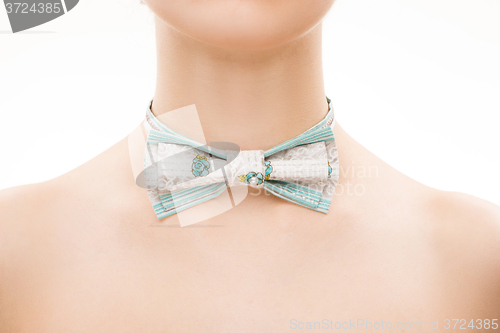 Image of patterned tie bow on female neck. 