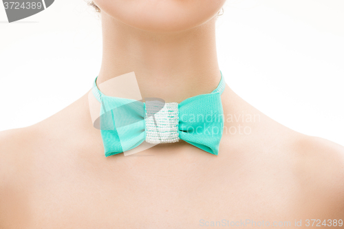 Image of green tie bow on female neck. 
