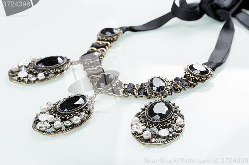 Image of black necklace with stones on white 