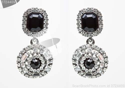 Image of earrings with black stones on the white