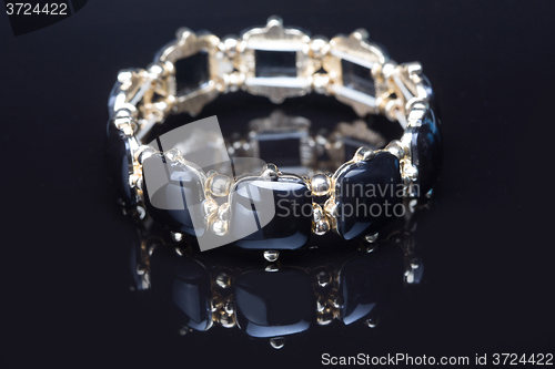 Image of Bracelet with black  stones over black 