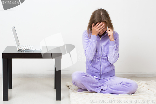 Image of distraught woman talking on the phone while 