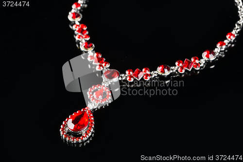 Image of Vintage pendant with ruby and crystals on   black background