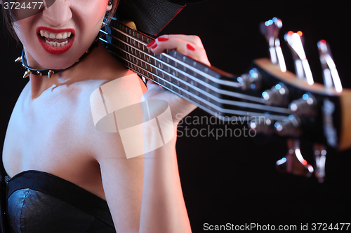Image of Fashion girl with guitar playing rock