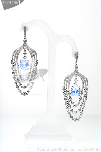 Image of earrings with blue stones on the white