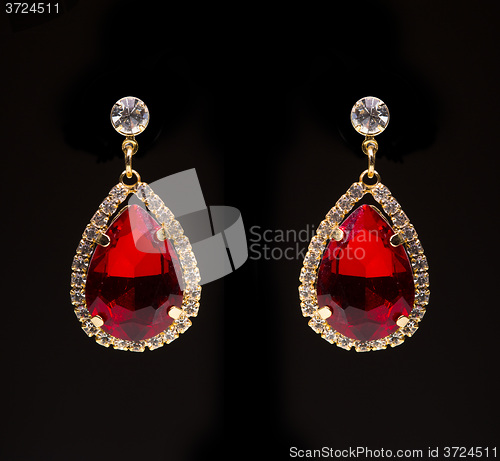 Image of earring with colorful red gems 