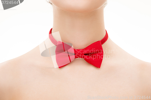 Image of red tie bow on female neck. 