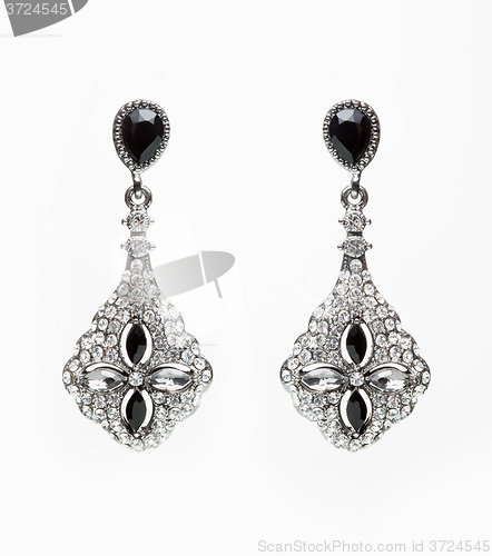 Image of earrings with black stones on the white