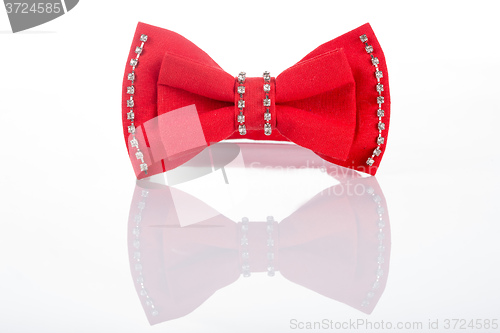 Image of red bow tie with sequins on a white background