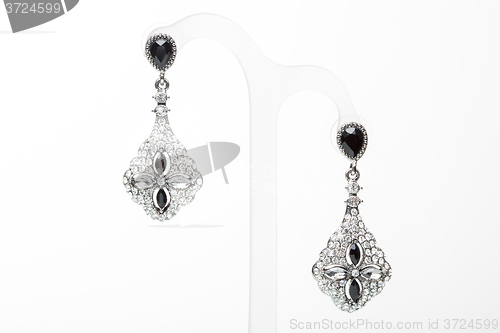 Image of earrings with black stones on the white