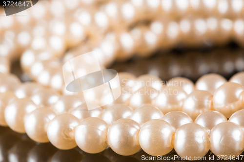 Image of White pearls on  black  background. luxury necklace.