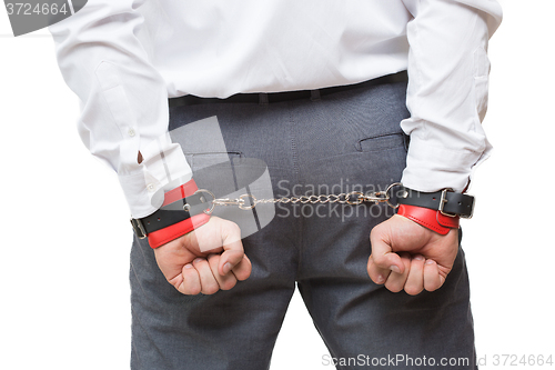 Image of man with chained hands. handcuffs for sex games. isolated on white background