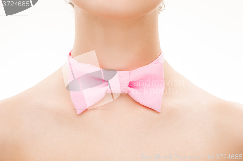 Image of pink tie bow on female neck. 