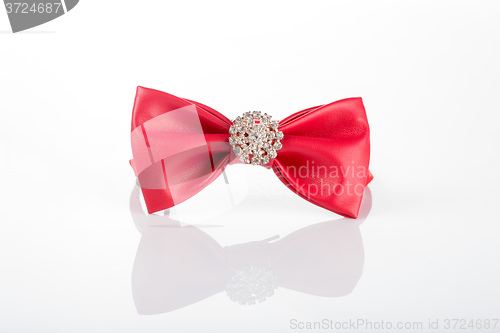 Image of red bow tie with sequins on a white background