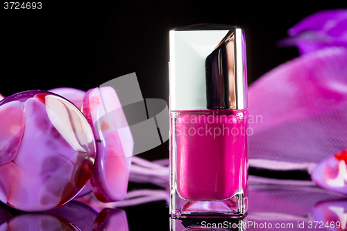 Image of magenta nail polish on  background of women\'s accessories